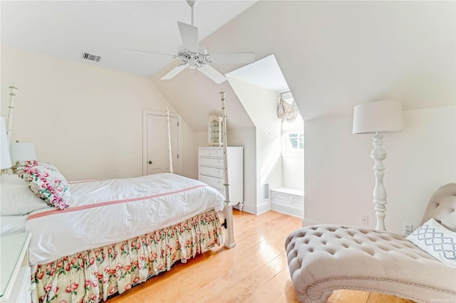 bedroom with hardwood / wood-style flooring, vaulted ceiling, and ceiling fan