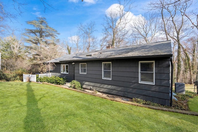 back of property with a yard, fence, and a chimney