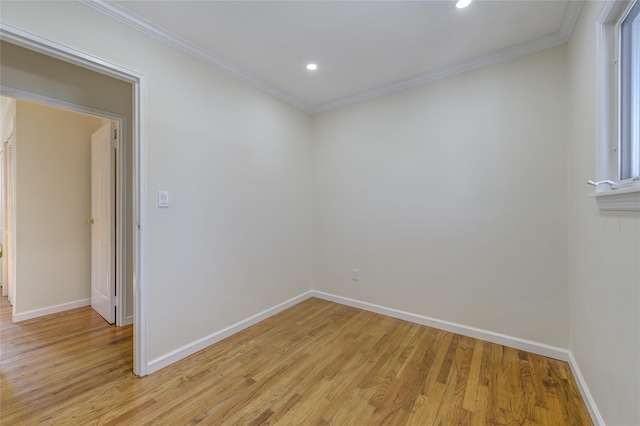 empty room with light wood-style floors, baseboards, and ornamental molding