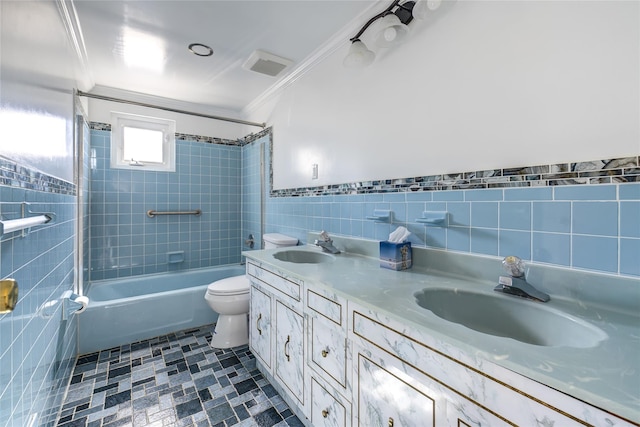 bathroom with double vanity, a sink, tile walls, and shower / bathing tub combination