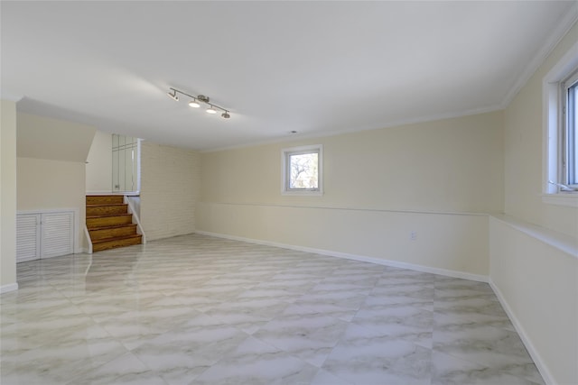 interior space featuring crown molding, baseboards, and stairs