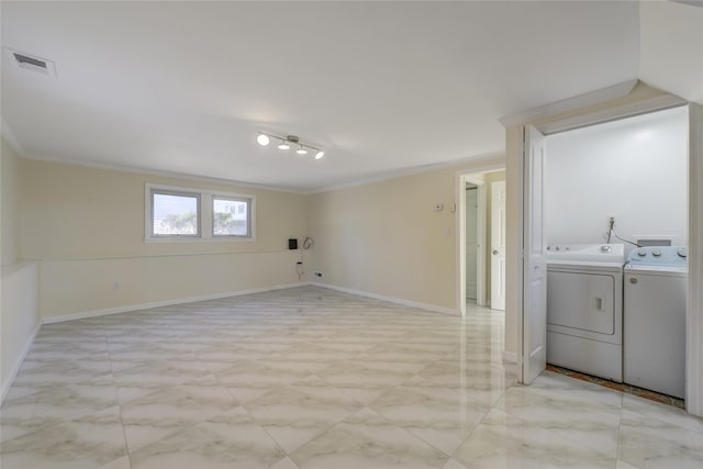 washroom featuring baseboards, visible vents, ornamental molding, and independent washer and dryer