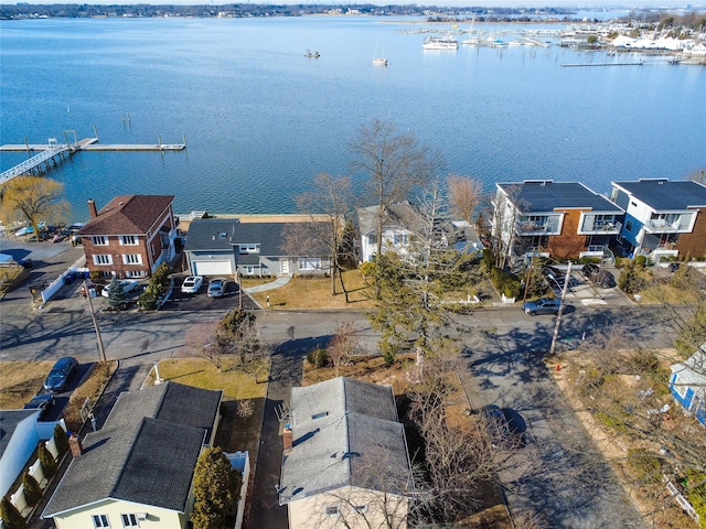 drone / aerial view featuring a residential view and a water view