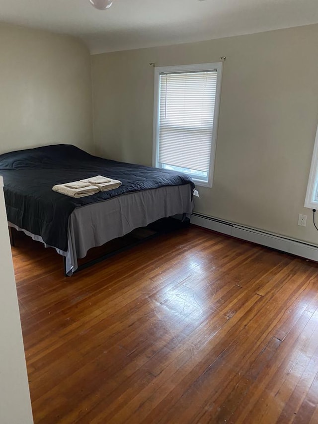 unfurnished bedroom with dark hardwood / wood-style flooring