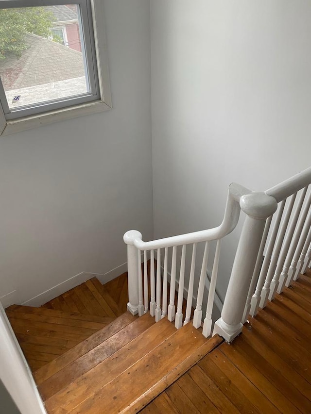 staircase with hardwood / wood-style floors