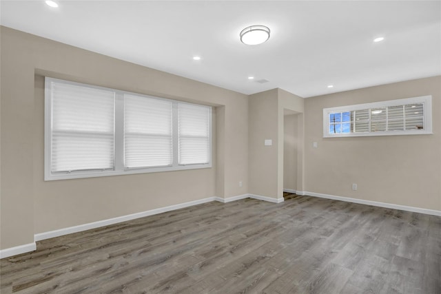 empty room with hardwood / wood-style flooring