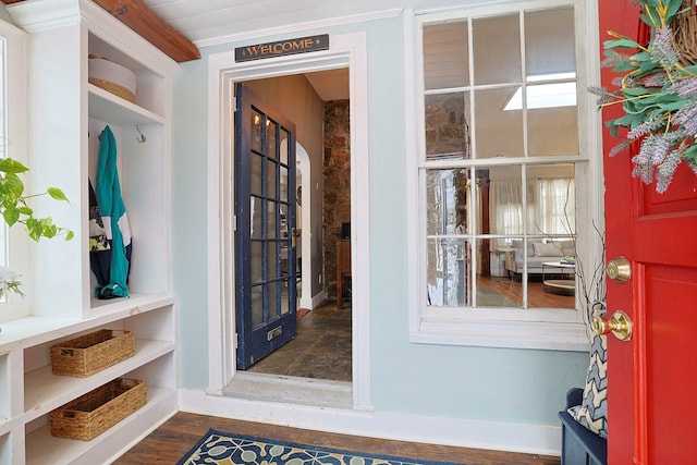 interior space with ornamental molding and dark hardwood / wood-style flooring