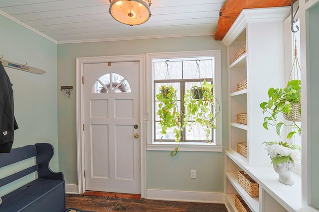 foyer entrance with crown molding and dark wood-type flooring