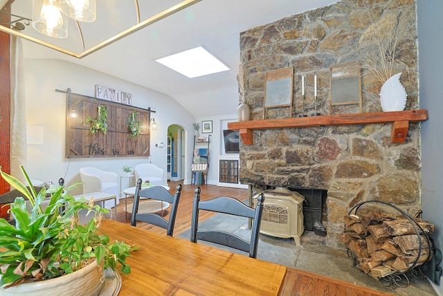 dining space featuring hardwood / wood-style flooring and lofted ceiling