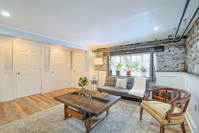 living room featuring crown molding and light wood-type flooring