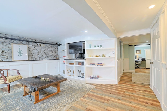 living room featuring crown molding and light wood-type flooring