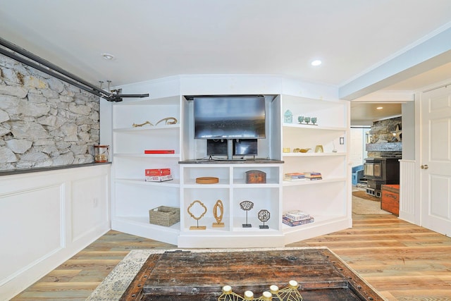 interior space with hardwood / wood-style flooring and crown molding