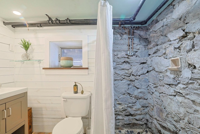 bathroom featuring vanity, curtained shower, and toilet