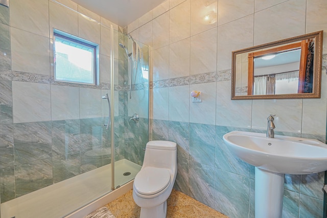 full bathroom featuring a stall shower, tile walls, and toilet