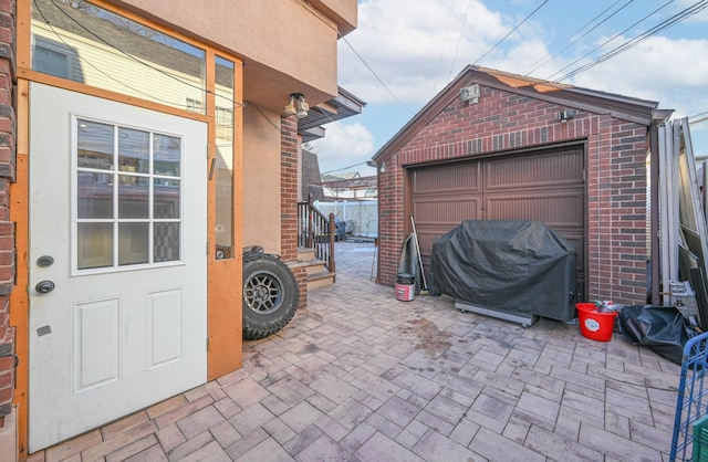 exterior space featuring a grill, a detached garage, and an outdoor structure