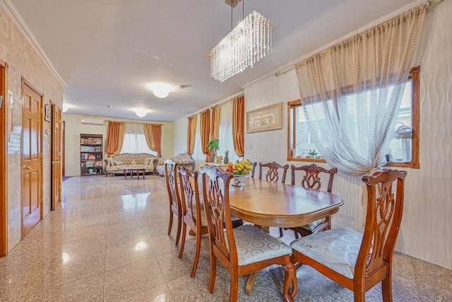 dining space featuring a chandelier, an AC wall unit, crown molding, and granite finish floor