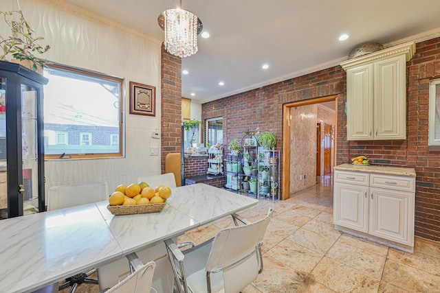 kitchen with cream cabinets, brick wall, a kitchen bar, and decorative light fixtures