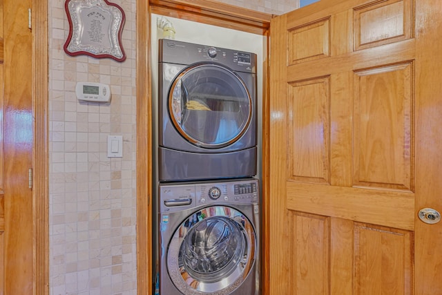 laundry room with stacked washer / dryer