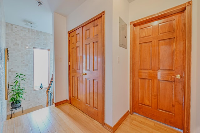 entryway featuring baseboards and light wood finished floors