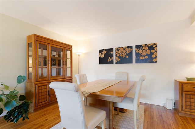 dining area with light wood finished floors