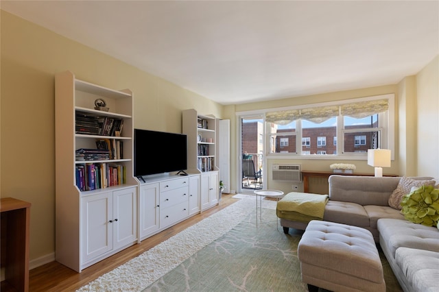 living room featuring light wood-type flooring, a wall unit AC, and a wealth of natural light