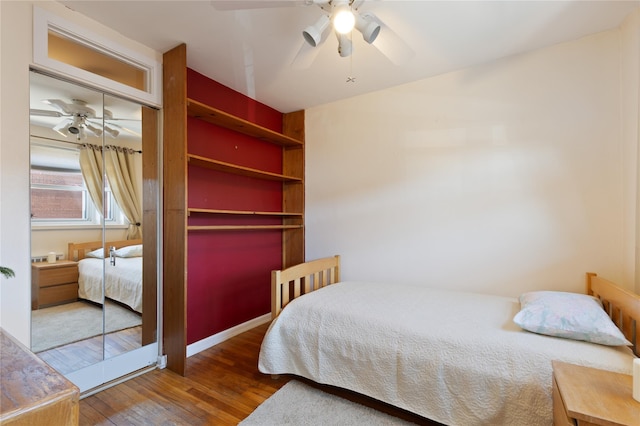 bedroom featuring a closet, ceiling fan, and wood finished floors