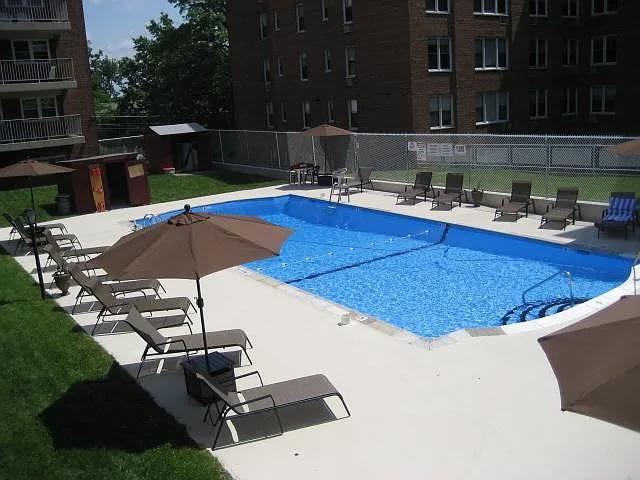 pool with a patio and fence