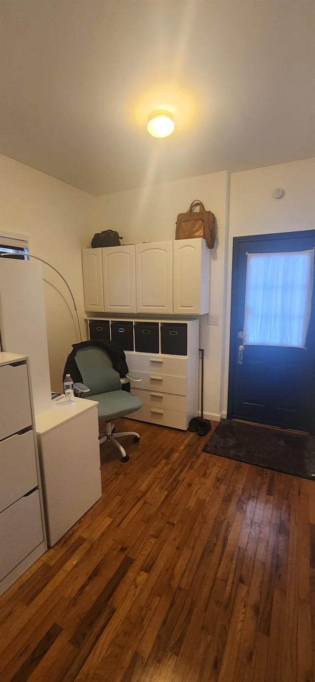 unfurnished office with dark wood-style flooring