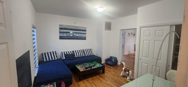 bedroom featuring a closet, visible vents, and wood finished floors