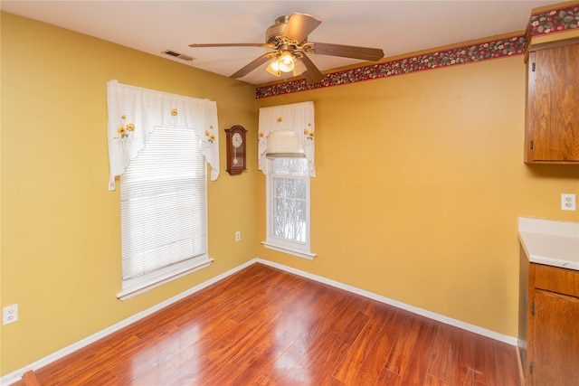 unfurnished dining area with hardwood / wood-style floors and ceiling fan