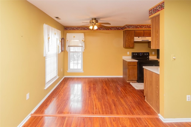 kitchen with black electric range, light hardwood / wood-style floors, and ceiling fan