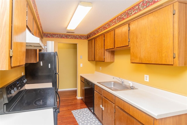 kitchen with sink, dark hardwood / wood-style floors, and black appliances