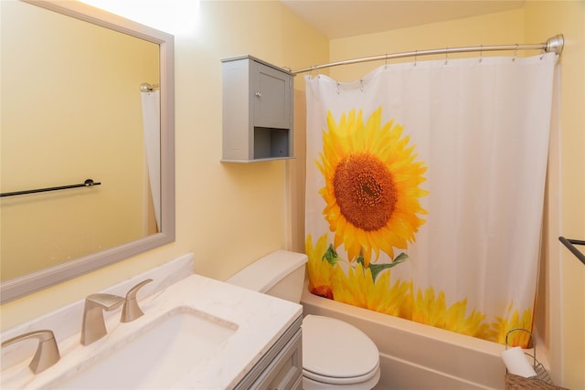 full bathroom with vanity, shower / tub combo, and toilet