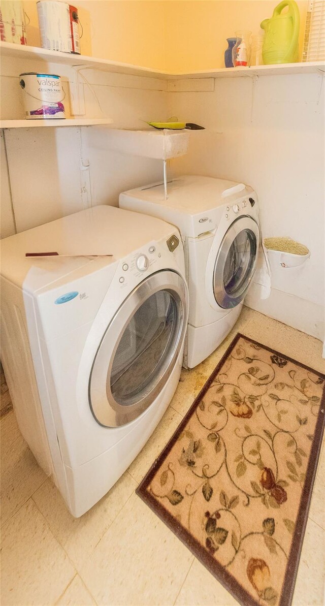 clothes washing area with separate washer and dryer