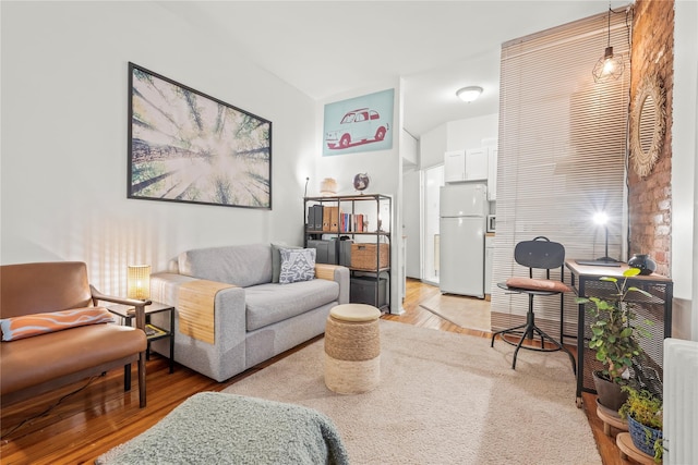 living room with radiator and light hardwood / wood-style flooring