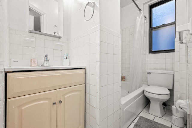 full bathroom featuring tile walls, vanity, toilet, shower / bath combo, and tile patterned floors