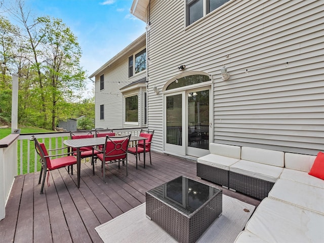 deck featuring outdoor dining space and outdoor lounge area