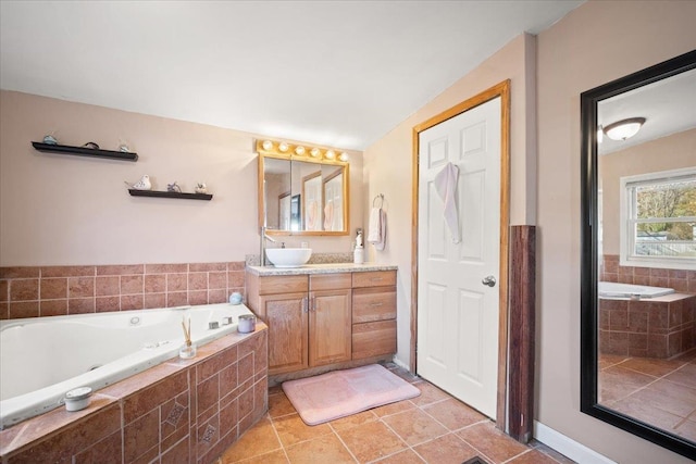 bathroom with a relaxing tiled tub, tile patterned floors, and vanity