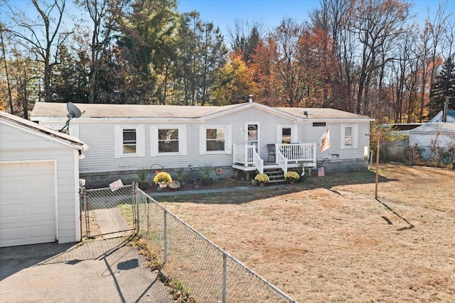 manufactured / mobile home with a garage and a front lawn