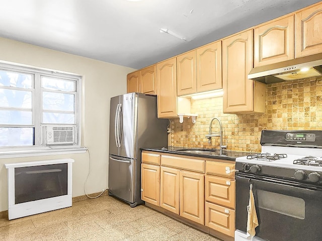 kitchen with sink, backsplash, range with gas cooktop, and stainless steel refrigerator