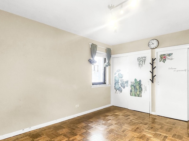 unfurnished room featuring parquet floors