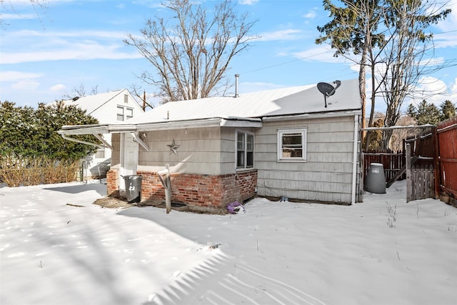 view of snow covered rear of property