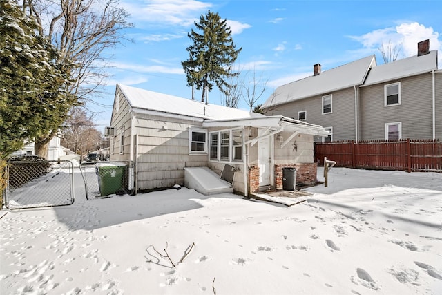 view of snow covered rear of property