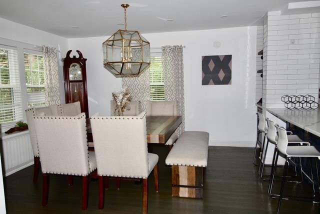 dining area with baseboards, dark wood-style flooring, and a healthy amount of sunlight