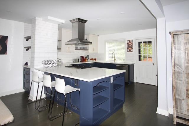 kitchen featuring a breakfast bar area, open shelves, white cabinets, island range hood, and a peninsula