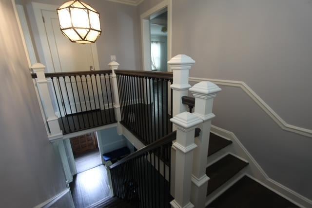 stairs featuring wood finished floors and baseboards