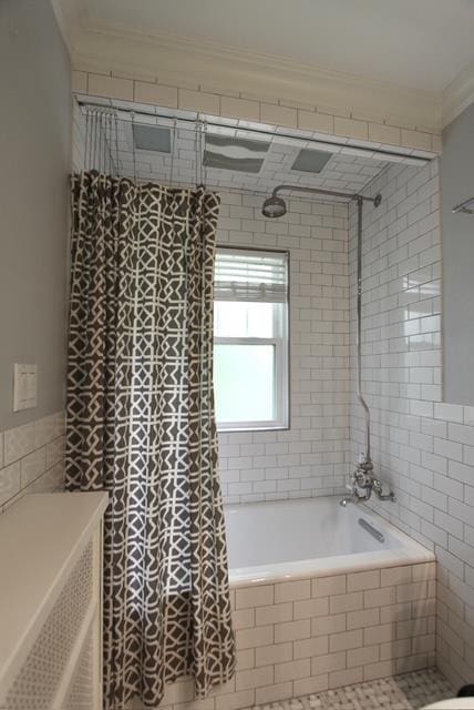 full bath featuring tiled shower / bath, ornamental molding, tile walls, and tile patterned floors