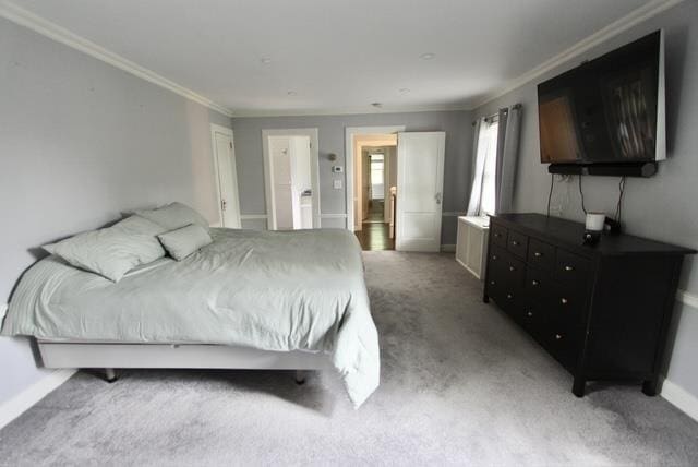 bedroom with ornamental molding, carpet, and baseboards