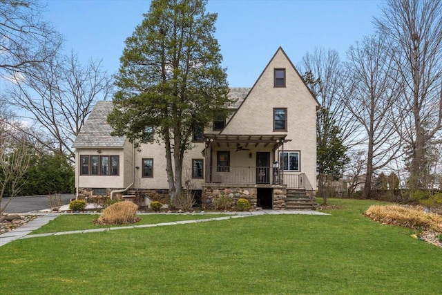 320 Putnam Ave, Port Chester, NY 10573 - view of front of home with a front yard, ceiling fan, covered porch, stucco siding, and stone siding