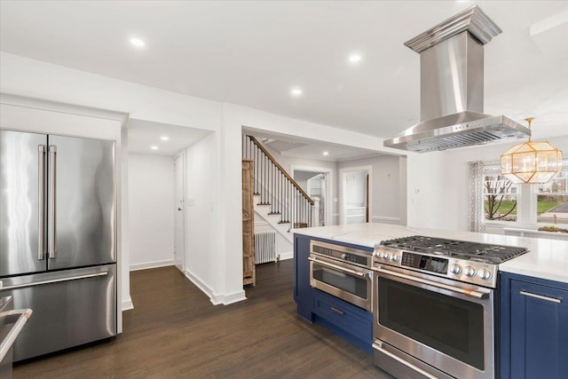 320 Putnam Ave, Port Chester, NY 10573 - kitchen featuring blue cabinets, stainless steel appliances, radiator heating unit, island range hood, and dark wood-type flooring